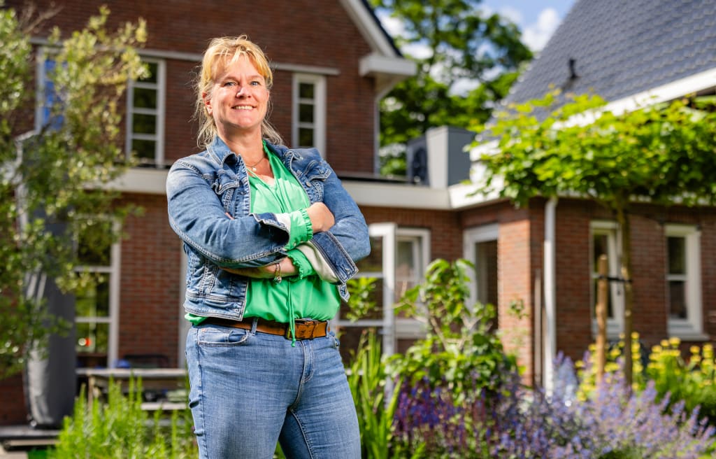 Vrouw in tuin voor huis in Noord-Veluwe