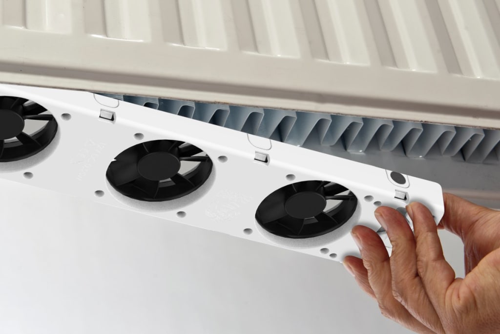 Radiatorventilator wordt onder een verwarming geplaatst